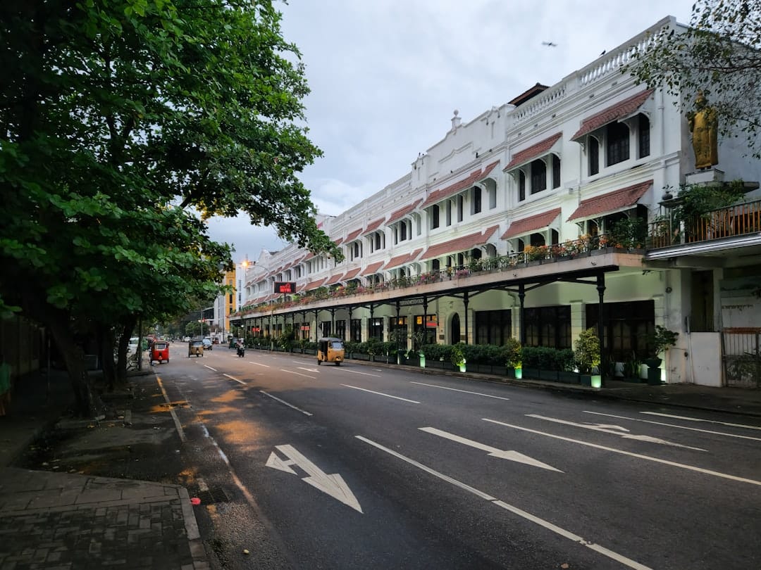 A street leads toward a large white building.