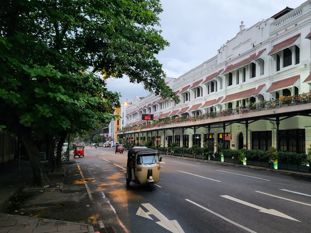A sri lankan street with old buildings and traffic.