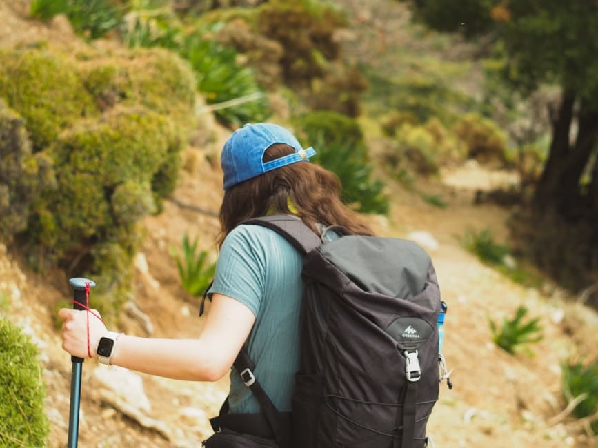 Back view of a hiker with backpack trekking through the scenic trails of Fethiye, Turkey.
