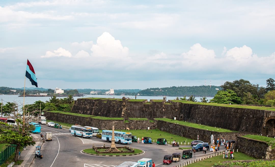 An old stone fortress with a busy road.