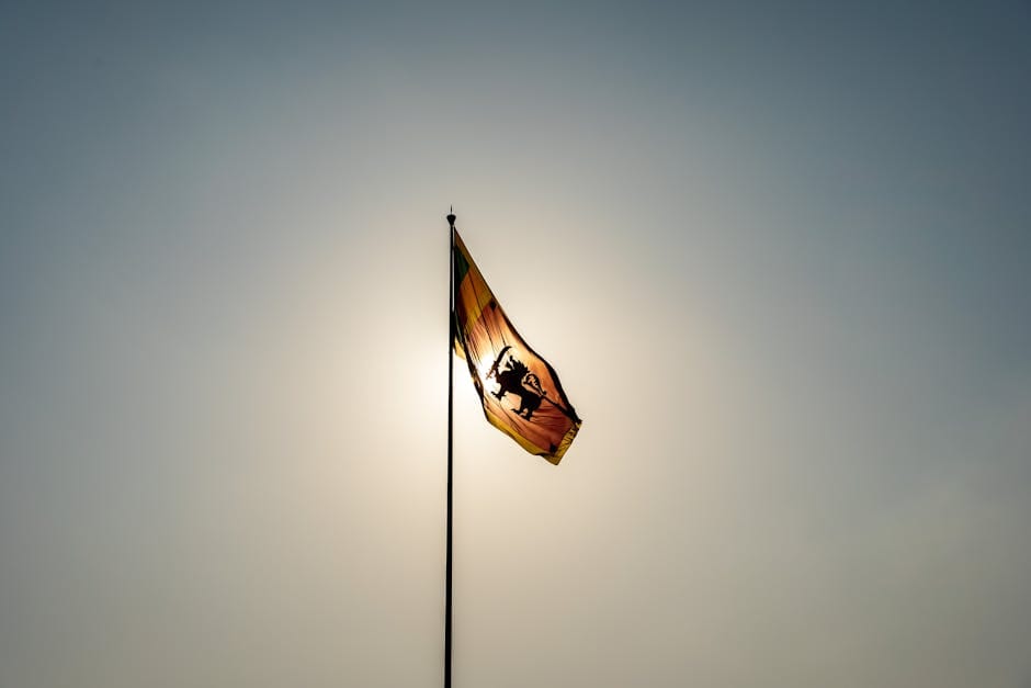 Sri Lankan flag waving against a clear sky in Colombo, symbolizing national pride.