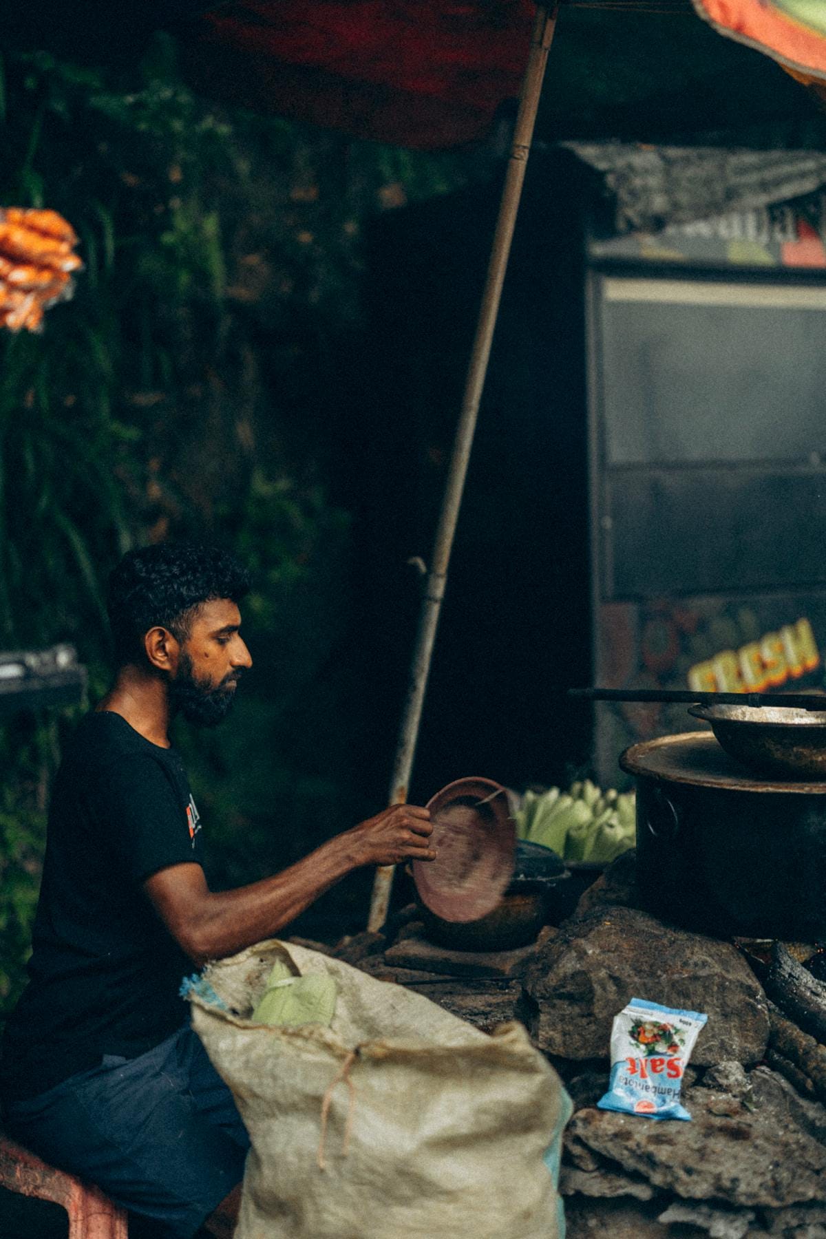 A street vendor in Sri Lanka prepares delicious local food outdoors